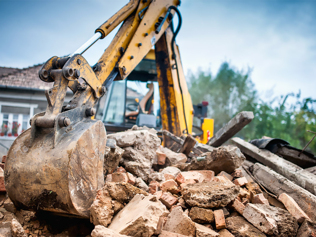 Digger demolishing a house knockdown rebuild Valley Homes