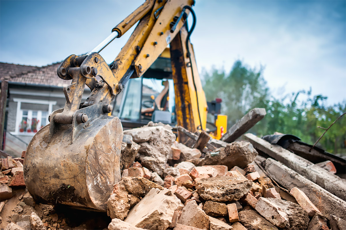 Digger demolishing a house knockdown rebuild Valley Homes