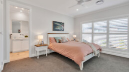 bedroom with white walls and plantation shutters