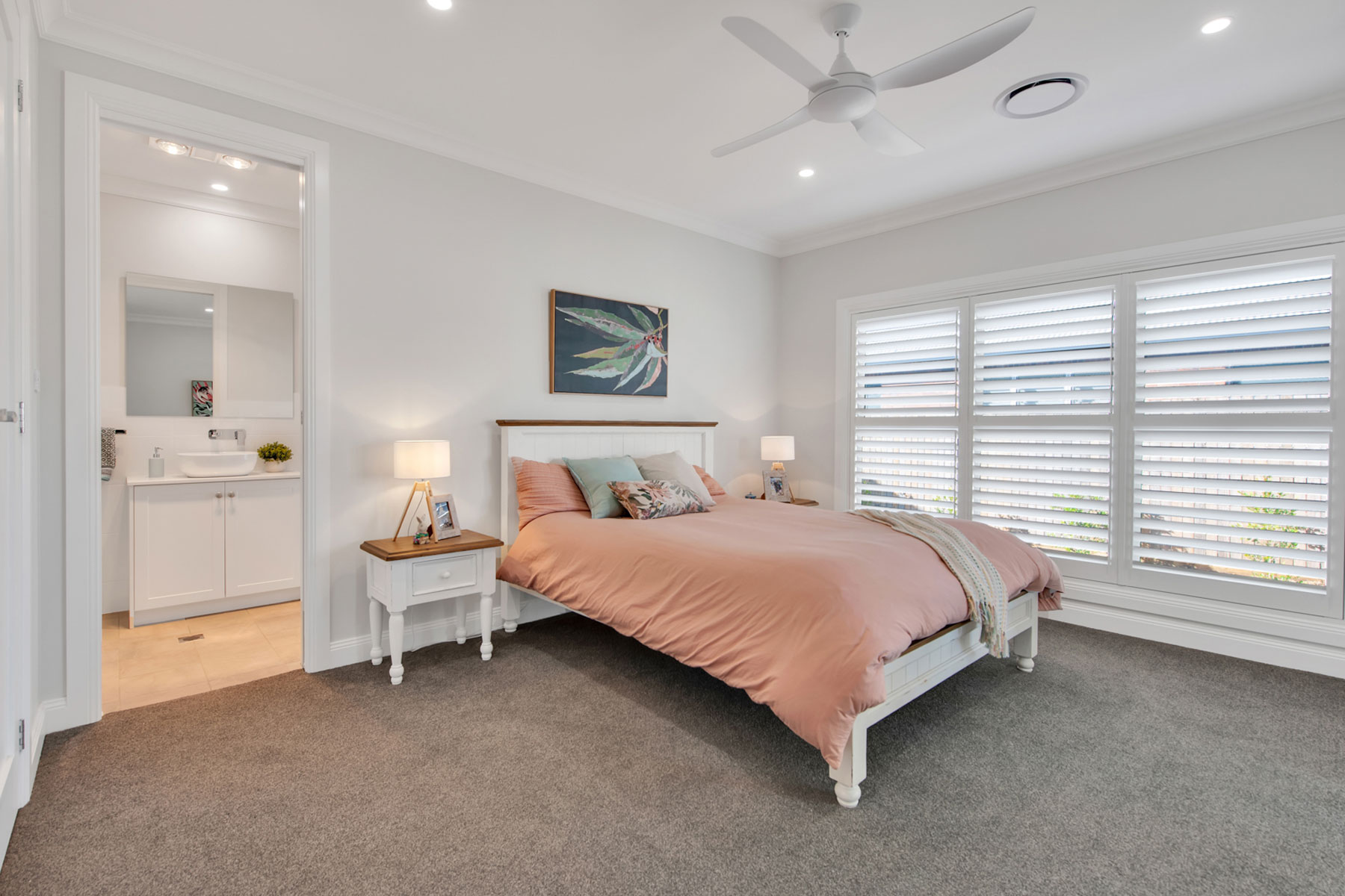 bedroom with white walls and plantation shutters