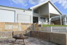 fire pit in back yard of with sandstone blocks