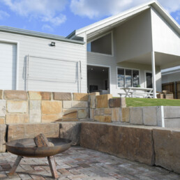 fire pit in back yard of with sandstone blocks