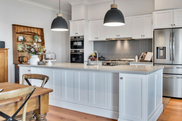 white hamptions style kitchen with grey splashback tiles