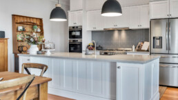 white hamptions style kitchen with grey splashback tiles