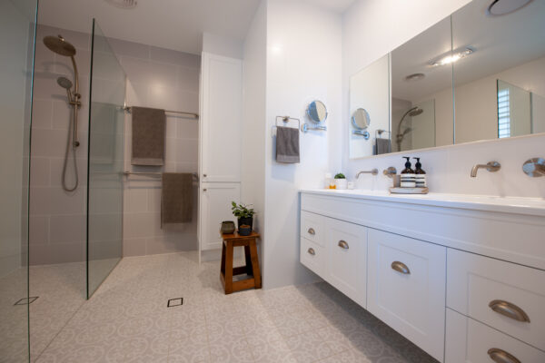 white spacious main bathroom with moroccan style floor tiles in light grey