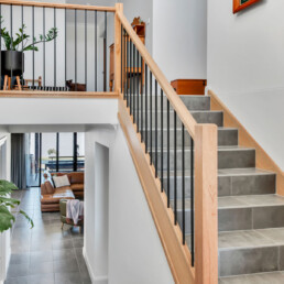 stairs showing split levels, look down to loung room and look up to landing space