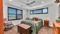 bedroom with black framed windows and rustic style bed