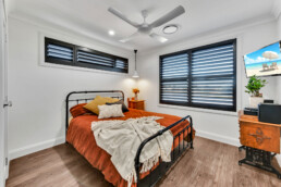 bedroom with black framed windows and rustic double bed