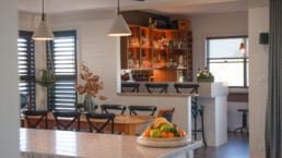 dining area looking into built in bar ares and liquor cabinets