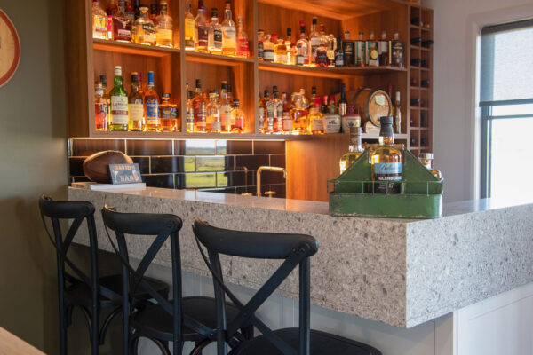 close up of bar with bar stools and liquor cabinet