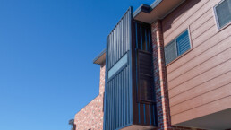 architectural feature of window area upstairs in black colour bond