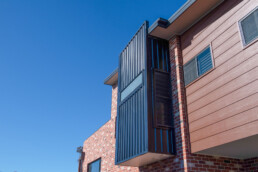 architectural feature of window area upstairs in black colour bond